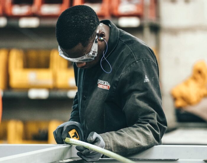 Black skilled trades worker using measuring tape